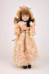 Játékbaba barackszínű ruhában